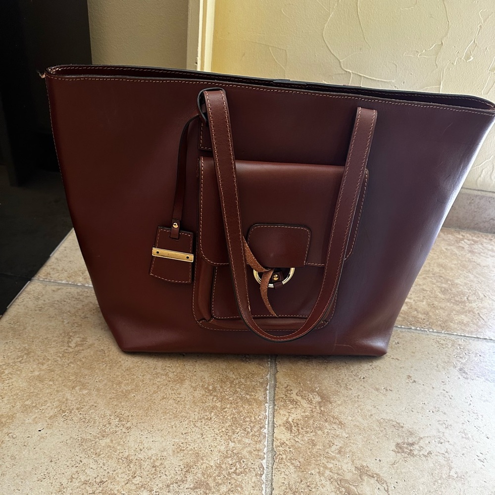 genuine leather made in Italy gold trim with red lining compartment
